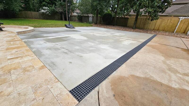 concrete driveway with channel drains installed in tomball tx